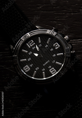  elegant silver watch with black wood background
