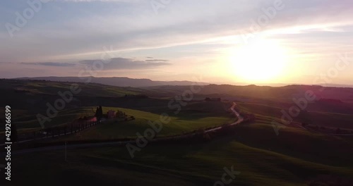 Colorful Tuscany field at sunset, Warm colors on the hills. Concept of traveling, holidays in Italy and outdoor activities