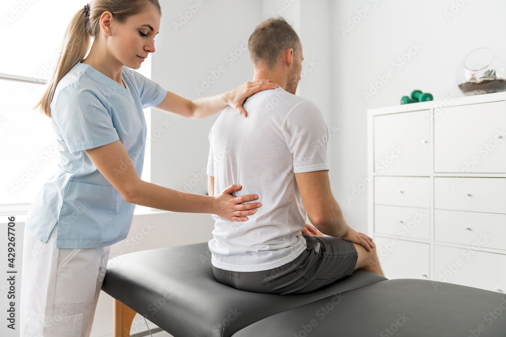 Obraz premium Patient at the physiotherapy doing physical exercises with his therapist