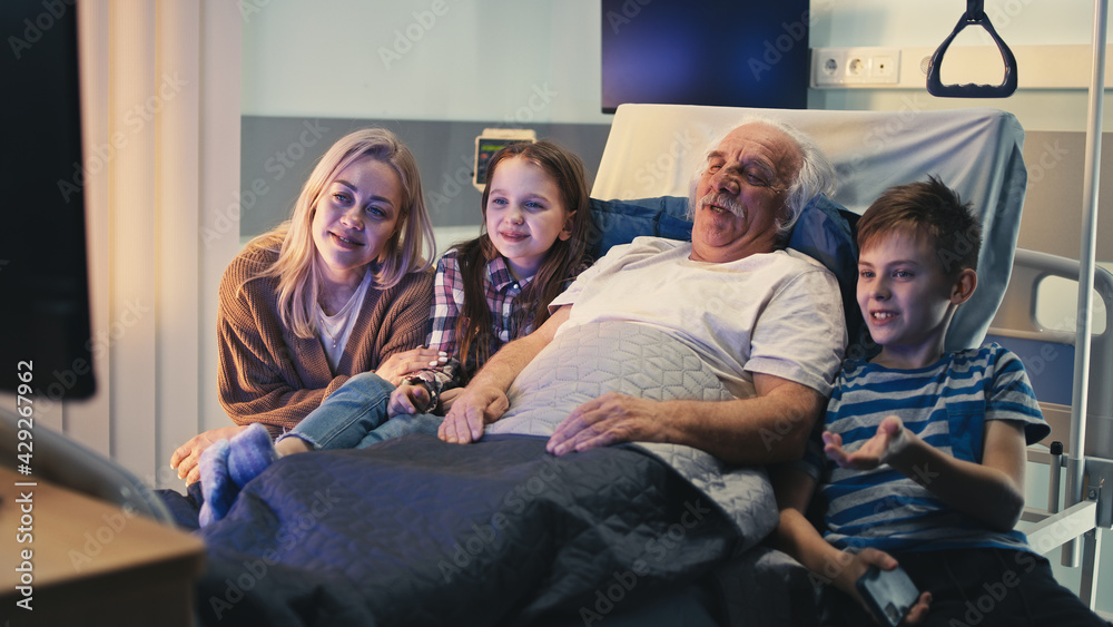 Elderly patient and visitors watching TV together Elderly patient and visitors watching TV together