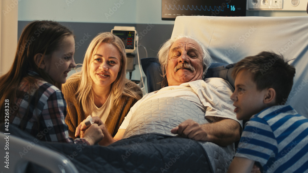 Senior patient speaking with daughter and grandchildren in hospital Senior patient speaking with daughter and grandchildren in hospital