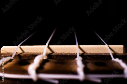 Close Up of Ukulele Bridge in Darkness
