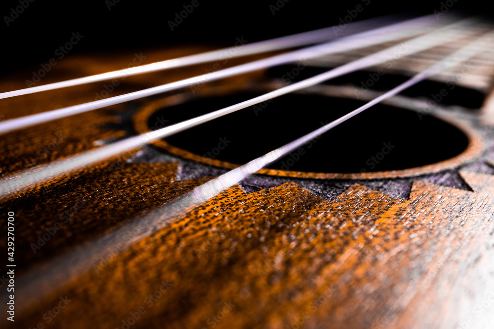 Angled View of Ukulele Strings and Soundhole Angled View of Ukulele Strings and Soundhole