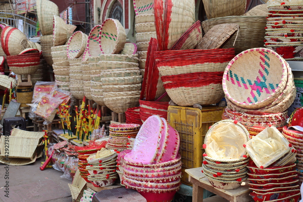 A tribal shop selling a variety of traditional wooden materials and colorful bamboo basket in all sizes.