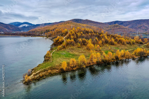 Lake Baikal in autumn. Cape Shamansky and Khamar-Daban ridge. Aerial view.