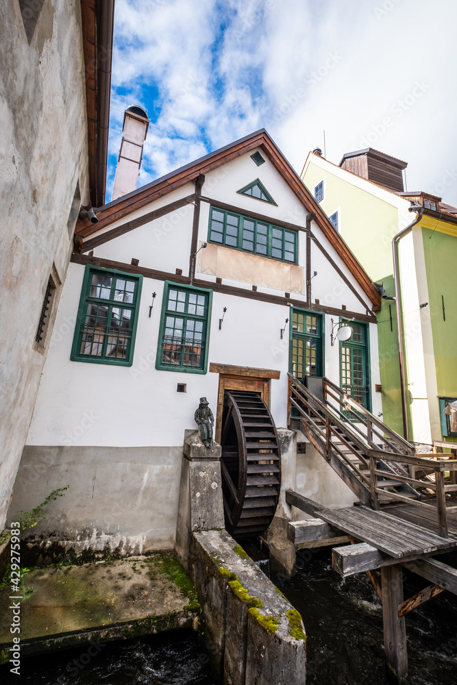 View of white music bar building with big watermill in Cesky Krumlov View of white music bar building with big watermill in Cesky Krumlov