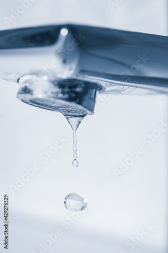 Water drops and faucet close up