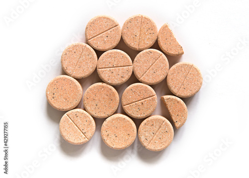 Colored pills on a white background. Round herbal tablets close-up. Healthcare and medicine.