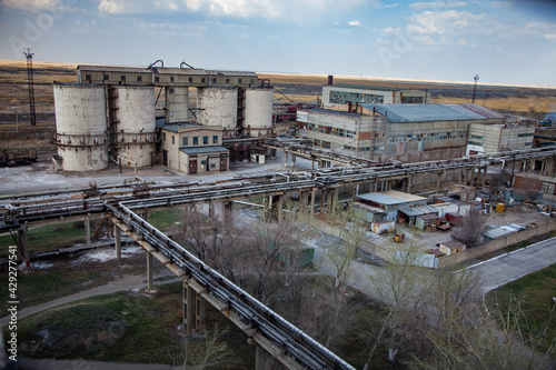 Outdated Soviet mining and processing plant. Concrete elevator and industrial building. © Alexey Rezvykh