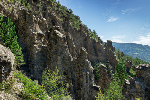 Astonishing rock formations called bridesmaids with hair (Demoiselles coiffées) in Theus and Remollon french villages in Alps region.