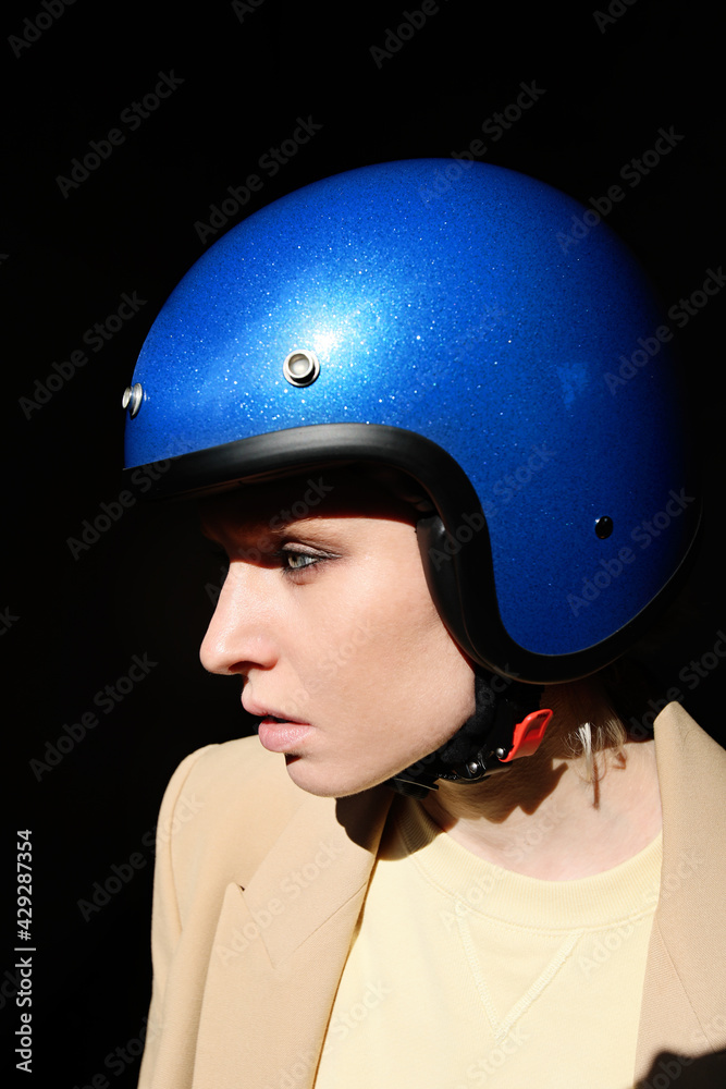 Young woman posing with blue retro helmet. Vertical. Young woman posing with blue retro helmet. Vertical.