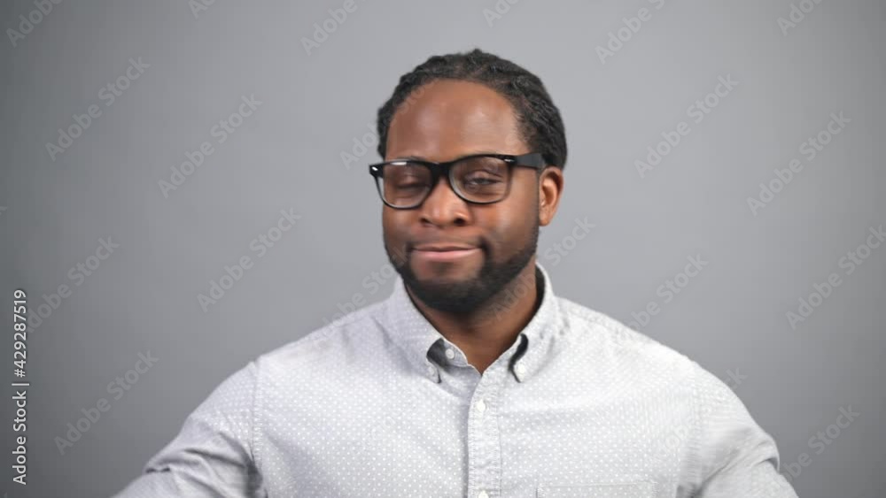 Serious African-American man with locks disagreeing with you isolated on grey, a black guy looks at the camera and nodding no, rejection concept Serious African-American man with locks disagreeing with you isolated on grey, a black guy looks at the camera and nodding no, rejection concept