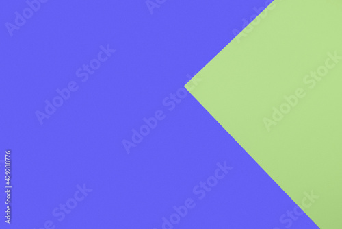 Abstract geometric background of light green and classic blue sheets of watercolor paper. Multicolored backdrop, minimal shapes.