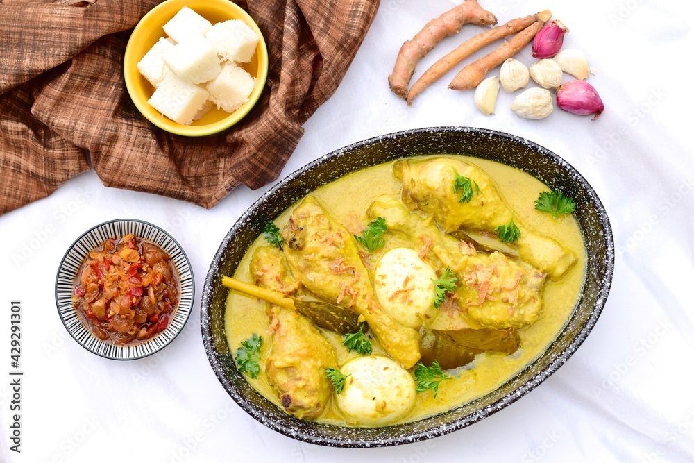 Opor ayam, chicken cooked in coconut milk from Indonesia, from Central Java, served with lontong and sambal. Popular dish for lebaran or Eid al-Fitr 