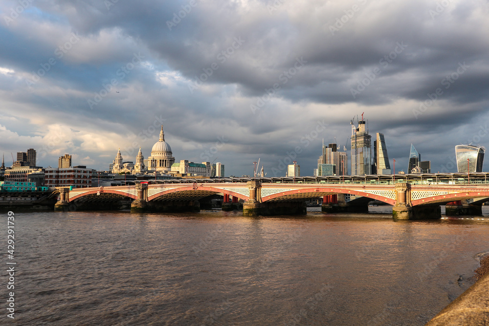 onderful summer sunset and cloudy sky over Blackfriars bridge and some of the most popular London city attractions sush as St. Paul`s cathedral and walkie talkie skyscraper