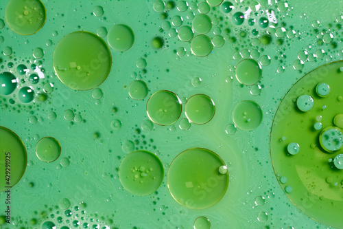 acrylic paint, green sea waves with green holes, with circles that have gold edges