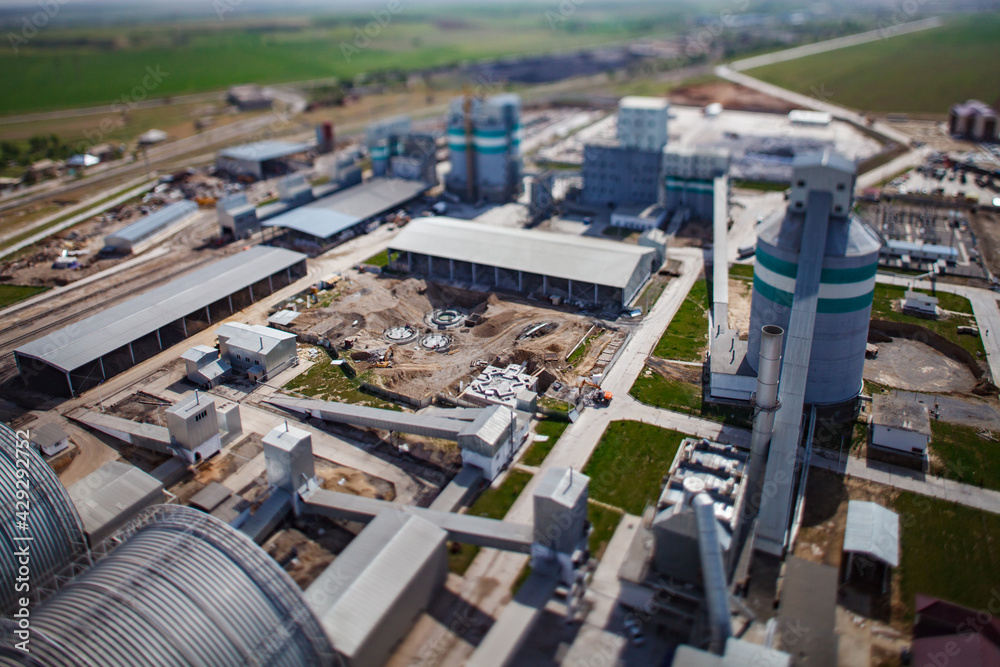 Standard Cement plant. Development of new industrial buildings. Reinforcement steel, concrete and groundworks. Tilt-shift partially blurred effect.
