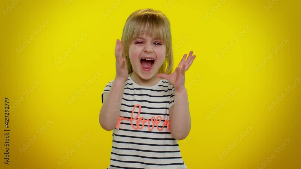 Unhappy frustrated annoyed little blonde teen kid child girl raising hands in displeased expression, quarreling asking reason of conflict, depression. Yellow studio background. Young children emotions Unhappy frustrated annoyed little blonde teen kid child girl raising hands in displeased expression, quarreling asking reason of conflict, depression. Yellow studio background. Young children emotions