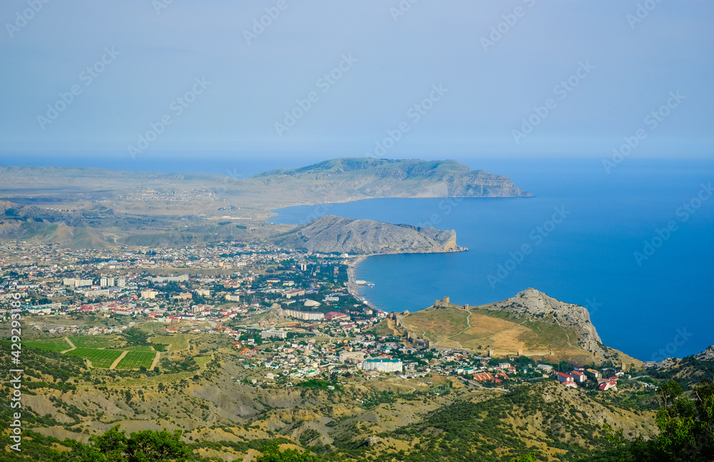 View from the top of the mountain to the city Sudak. A city by the sea.