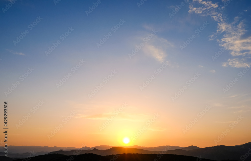 Sunset in the mountains. Layered mountains. Haze at sunset.