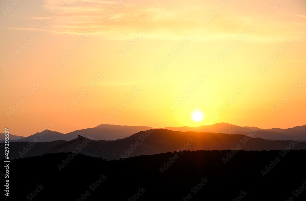 Sunset in the mountains. Layered mountains. Haze at sunset. Sunset in the mountains. Layered mountains. Haze at sunset.