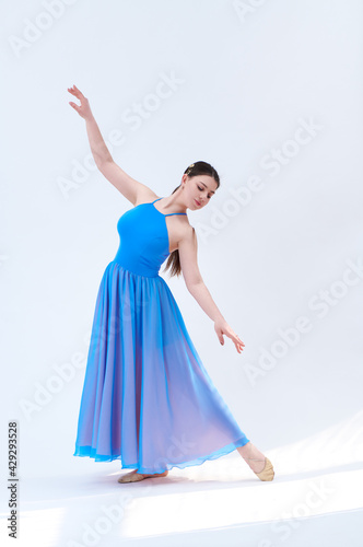 girl beautiful dress is engaged in dancing in the studio