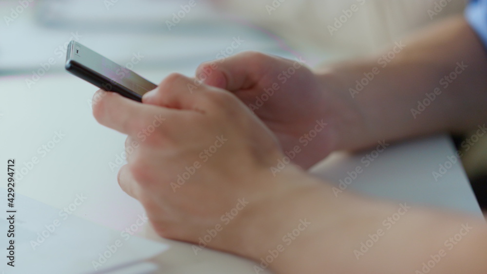 Man hands surfing internet mobile phone. Male person working smartphone indoors Man hands surfing internet mobile phone. Male person working smartphone indoors