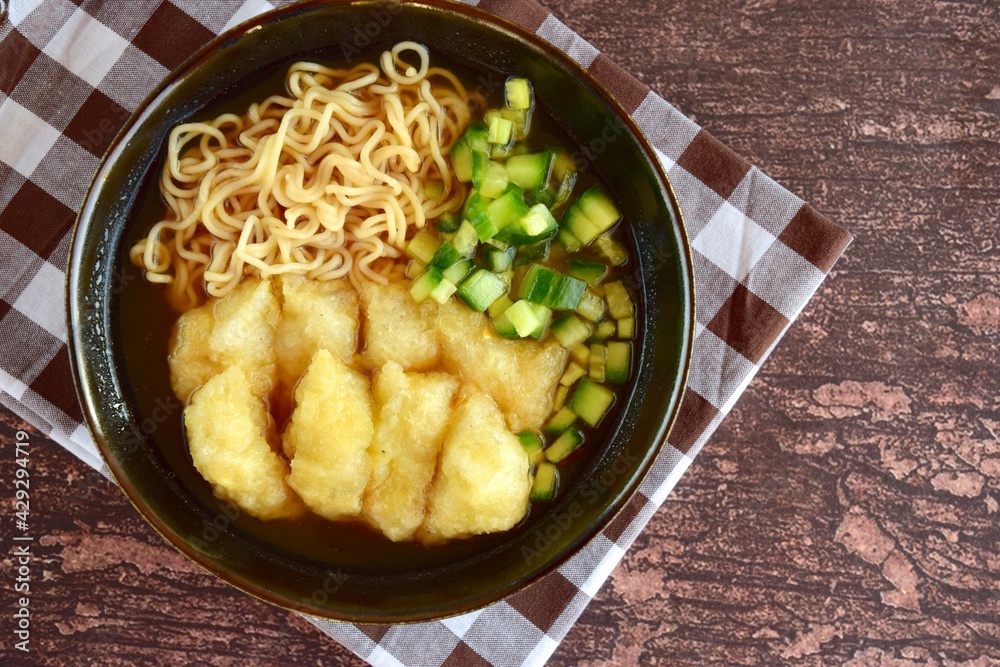 Pempek or mpek-mpek, popular savory fish cake dish from Palembang, South Sumatra, Indonesia. Served in sweet and sour sauce (kuah cuka) accompanied with noodles, cucumbers