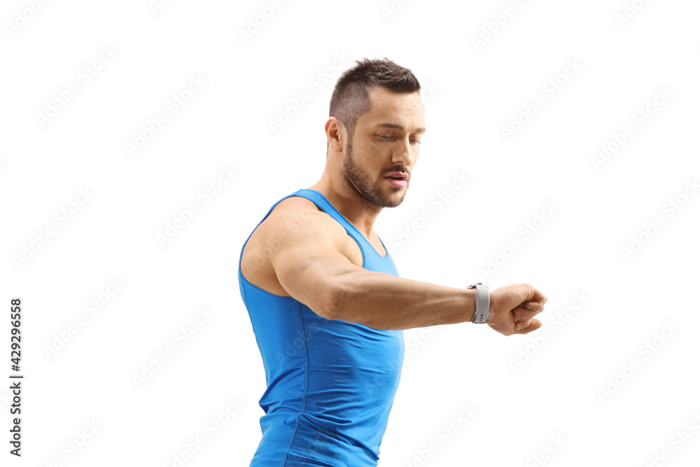 Athlete guy looking at his smartwatch Athlete guy looking at his smartwatch