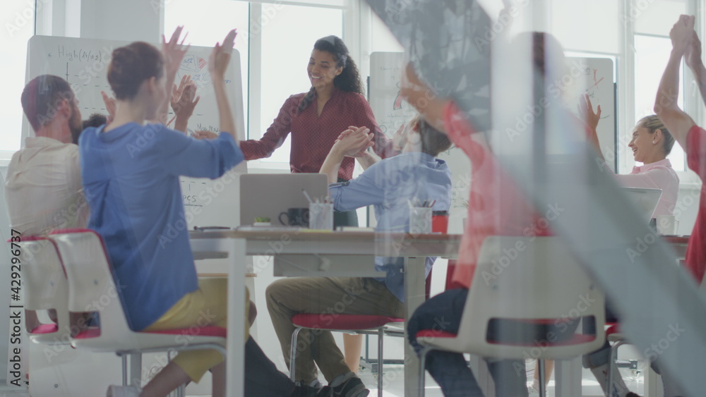 Through glass people applauding african woman. Colleagues celebrating success. Through glass people applauding african woman. Colleagues celebrating success.