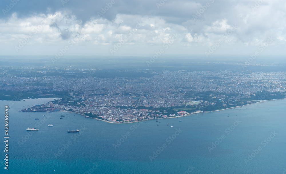 Aerial view on Stone Town, the major city of Zanzibar. Zanzibar is a tanzanian island in the indian ocean, blue ocean sea background