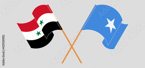 Crossed and waving flags of Syria and Somalia