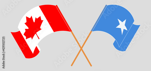 Crossed and waving flags of Canada and Somalia