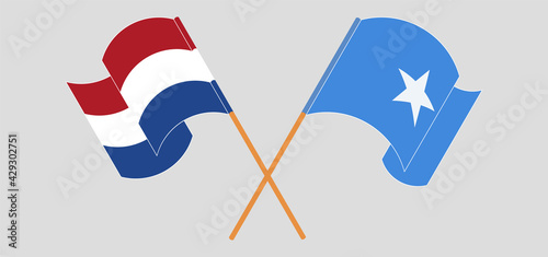 Foto Crossed and waving flags of the Netherlands and Somalia