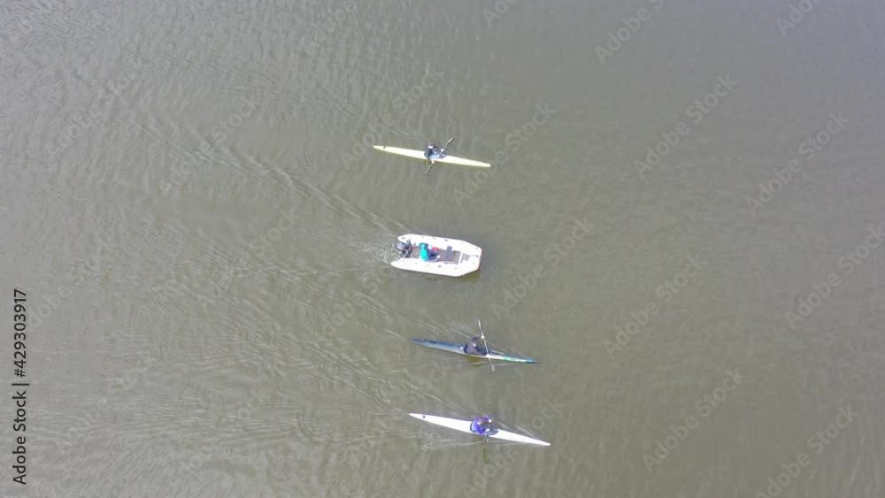 People Kayaking on River. Center for Sports Training in Kayaking and Canoeing. Athletes in Training, City Rowing Canal. Kayak Water Sports. People Boating on River. View from above. Drone shooting People Kayaking on River. Center for Sports Training in Kayaking and Canoeing. Athletes in Training, City Rowing Canal. Kayak Water Sports. People Boating on River. View from above. Drone shooting