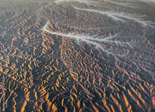 Obraz na płótnie Aerial View from an Airplane. Flying above Beautiful Land at Sunrise. w salonie