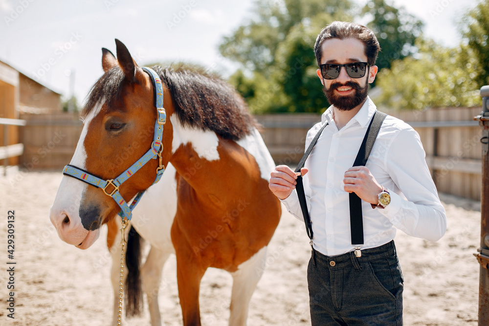 Fototapeta premium Handsme man standing in a ranch