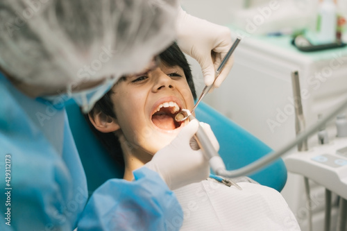 dark-haired boy with open mouth at the dentist