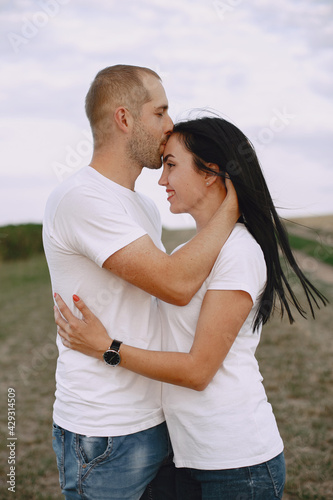 Beautiful couple spend time on a summer field