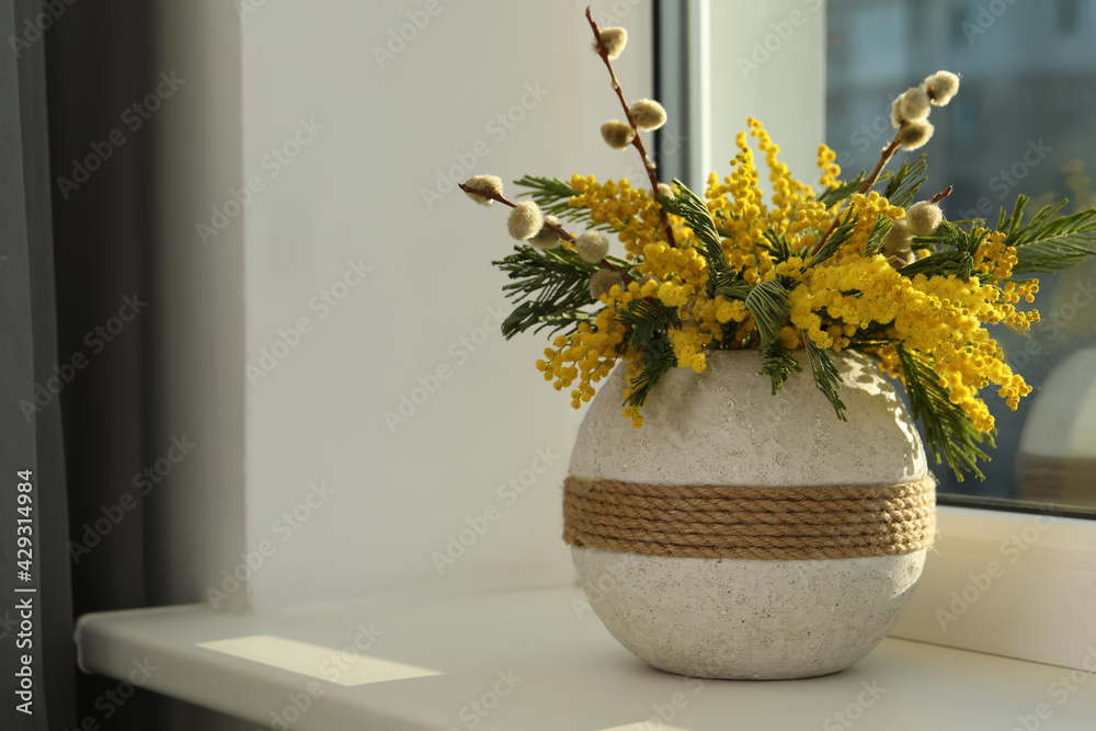 Beautiful mimosa flowers in vase on window sill indoors, space for text - obrazy, fototapety, plakaty 