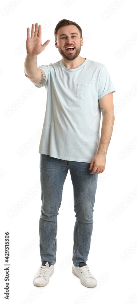 Happy young man waving to say hello on white background Happy young man waving to say hello on white background