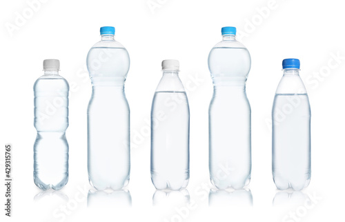 Set with different bottles of pure water on white background