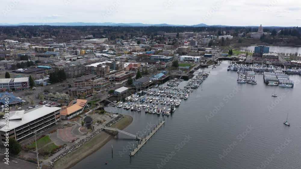 Cinematic dolly drone clip of West Bay, downtown Olympia, Farmers Market, Percival Landing Park, marinas and Heritage Park, panoramic view of Historic District, Capitol building in Olympia, Washington Cinematic dolly drone clip of West Bay, downtown Olympia, Farmers Market, Percival Landing Park, marinas and Heritage Park, panoramic view of Historic District, Capitol building in Olympia, Washington