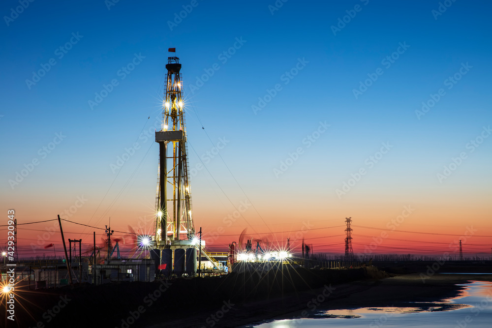 In the evening of oilfield derrick