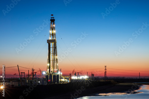In the evening of oilfield derrick photo