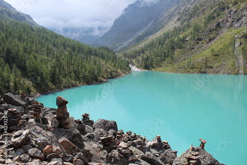 Stone city above the Middle Shavlin turquoise lake in the Altai Mountains