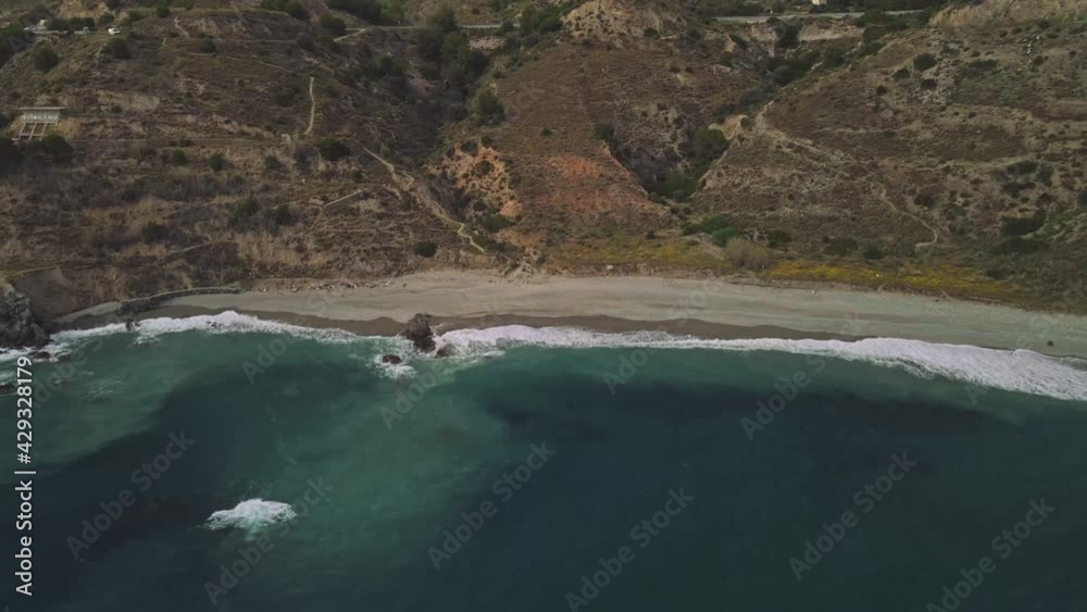 Drone flying sideways at the coastline of Nerja, South of Spain, tilting up into the horizon Drone flying sideways at the coastline of Nerja, South of Spain, tilting up into the horizon