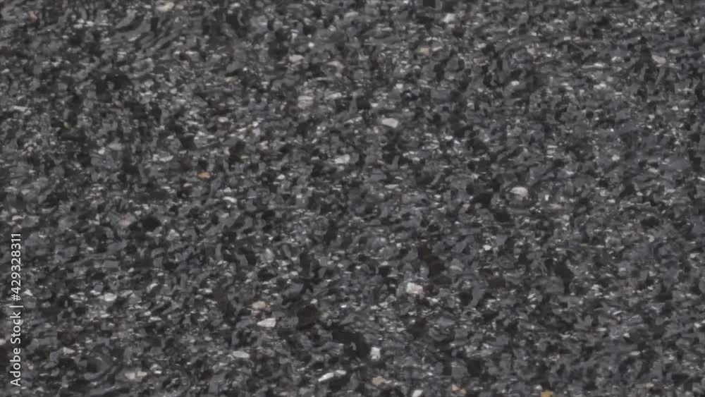 Beautiful Close up of a Lisbon street with rain running on the asphalt Beautiful Close up of a Lisbon street with rain running on the asphalt