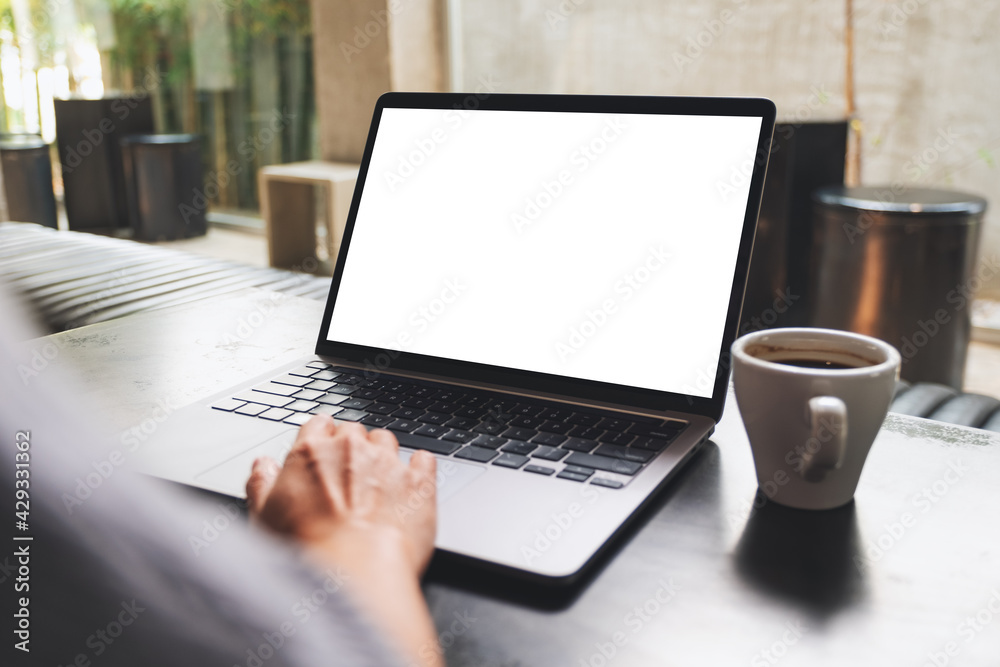 Mockup image of a woman using and touching on laptop touchpad with blank white desktop screen Mockup image of a woman using and touching on laptop touchpad with blank white desktop screen