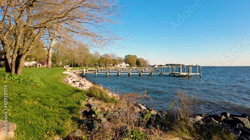 Waterfront region of the charming small town Oxford, Maryland where upscale vacation homes have access to individual docks for sailing. Panning footage shows the Tred Avon river leading to Chesapeake  photo